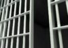 Close-up view of prison cell bars.