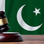 Gavel with Pakistan flag in the background.