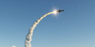 Missile launching into the sky with smoke trail.