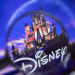 Disney castle logo under a magnifying glass.