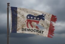 Democrat Freshman ATTACKS Veterans—Calls VA “Communist”… A weathered flag featuring the Democratic Party symbol and the word 'DEMOCRAT'