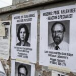 Bulletin board displaying missing person posters for two professionals