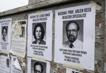 Bulletin board displaying missing person posters for two professionals