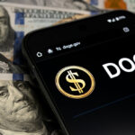 Smartphone displaying DOGE app over dollar bills