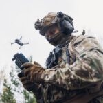 Soldier operating a drone while wearing tactical gear