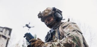Soldier operating a drone while wearing tactical gear