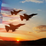 Three fighter jets fly in formation at sunset with a translucent U.S. flag overlay