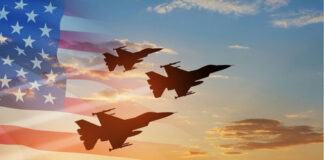 Three fighter jets fly in formation at sunset with a translucent U.S. flag overlay