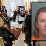 PARDONED Jan 6 Meme Man Demands Millions.. Individual holding a wooden podium inside a historic building during a protest
