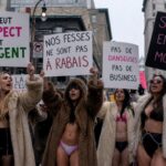 Group of women in fur coats holding protest signs in Montreal