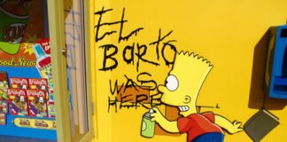 Graffiti of Bart Simpson writing El Barto was here on a yellow wall