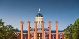 Historic building with columns at sunset, front view.