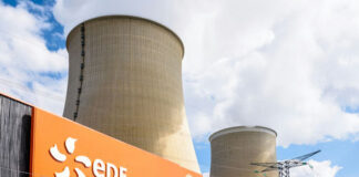 cooling towers at a power plant behind security fence