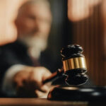 Judge's gavel striking sounding block in courtroom