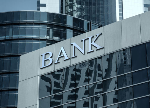 Bank building facade with large sign and glass windows