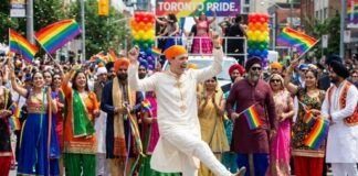 Participants in traditional attire celebrating at a Pride parade