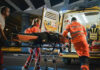 Buried Alive: Eight Days, One Hand Paramedics loading patient into ambulance at night.