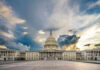 Hawks Panic After SHOCK Graham Exit U.S. Capitol building under a dramatic sky at sunset.
