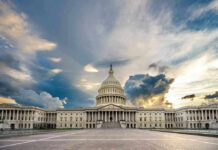 Hawks Panic After SHOCK Graham Exit U.S. Capitol building under a dramatic sky at sunset.