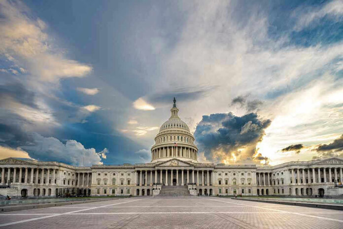 2110094846 U.S. Capitol building under a dramatic sky at sunset.