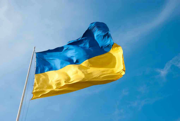379308763 Ukrainian flag waving against blue sky.