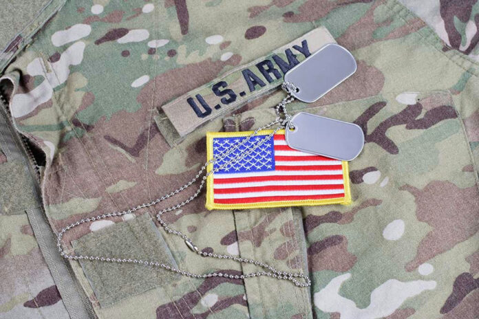 U.S. Army uniform with dog tags and flag patch.