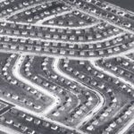 Aerial view of a suburban neighborhood featuring winding streets and rows of houses
