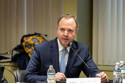 shutterstock2290525911-1jpg A man in a suit speaking into a microphone.