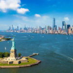 Statue of Liberty with New York City skyline background.