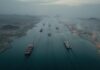 Aerial view of cargo ships navigating a shipping channel