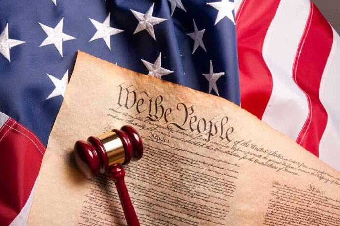 U.S. Constitution with gavel on American flag